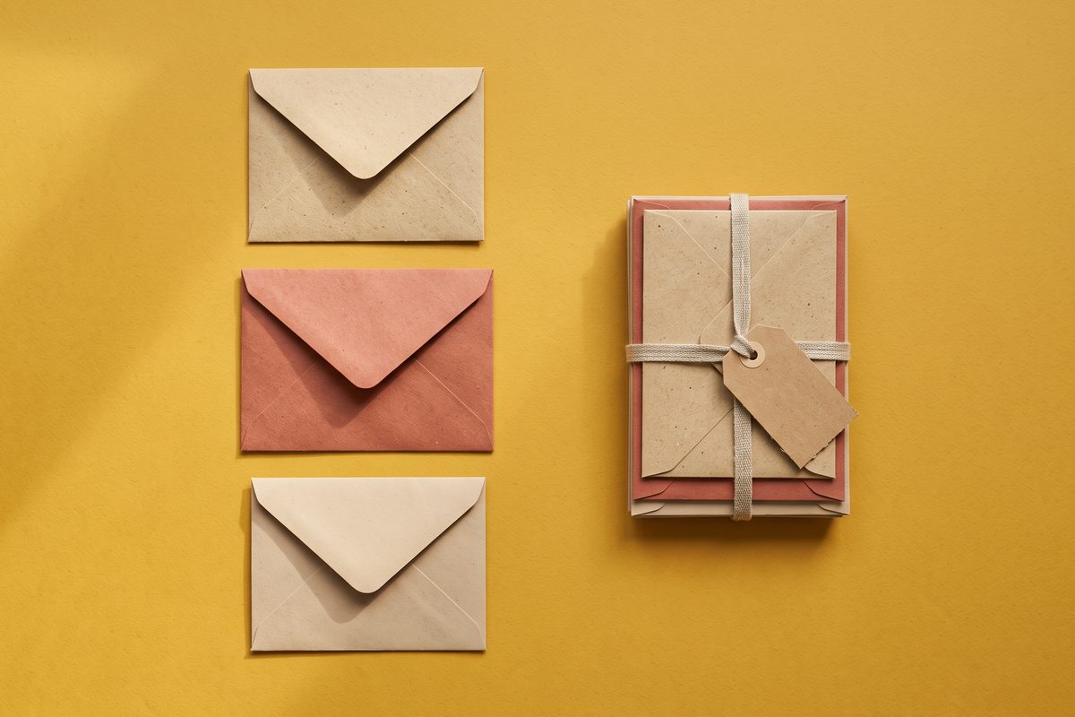 Three separate envelopes beside the same three bound into one bundle with a single tag.