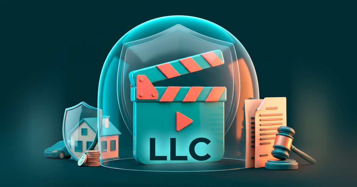 A film clapperboard marked LLC inside a protective shield dome, with a house, car and coins kept apart from legal papers and a gavel